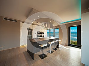 Interiors of a modern apartment, kitchen with sea view