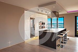 Interiors of a modern apartment, kitchen with sea view photo