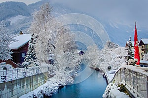 Interlaken landscape after snow in winter with river reflection, Swiss alps photo