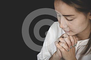 Interlocking hands praying for God`s blessings. The idea of praying to the Lord with patience and steadfastness