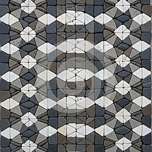 Interlocking stone pavement featuring a geometric pattern of curves and