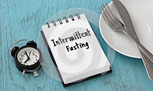 Intermittent fasting concept on blue table