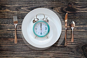 Intermittent Fasting Concept with Clock on Plate photo