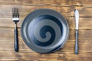 Intermittent fasting concept with empty black plate