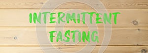 Intermittent fasting symbol. Concept words Intermittent fasting on beautiful wooden wall. Beautiful wooden wall background.