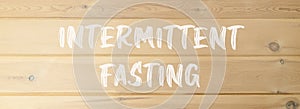 Intermittent fasting symbol. Concept words Intermittent fasting on beautiful wooden wall. Beautiful wooden wall background.