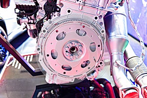 An internal combustion engine flywheel assembly on a store display case