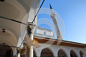 The internal courtyard of Emperor`s Mosque, located in Bistrik district, with arches, columns and the minaret in the background