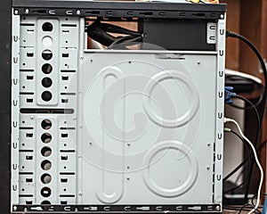 Internal part of the computer casing. Places for installation of hard drives and solid-state drives in the computer case