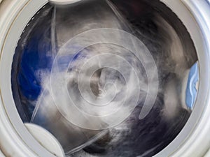 Internal view of a washing machine drum during wash. Top view.