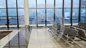 International Airport terminal hall, view of the airfield through the window, travel concept