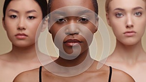 International beauty. Close up portrait of asian, african american and caucasian ladies looking seriously at camera