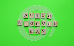 International Biodiesel Day, World Biofuel Day, minimalistic banner, inscription in wooden letters on a green
