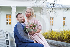 International bride and groom together in green city park