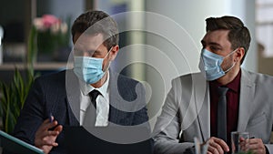 International business group discuss marketing wear face mask in diverse office.
