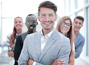 International business people standing with folded arms smiling at the camera