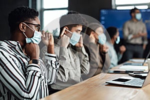 International business people wearing medical masks using laptops