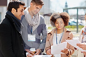 International business team with papers outdoors