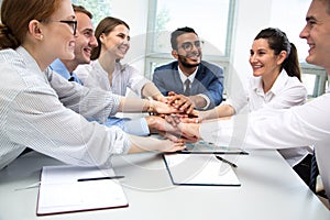 International business team showing unity with their hands