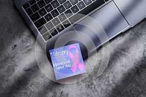 International Cancer Day posit on laptop keyboard. photo
