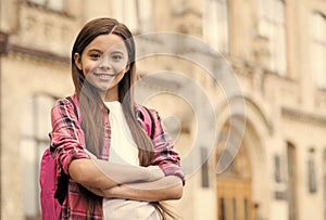 International childrens day. Confident child keep arms crossed in schoolyard. School education. November 20. Childrens