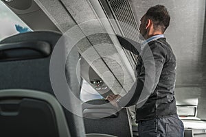 International Coach Bus Passenger Securing Luggage Inside Vehicle