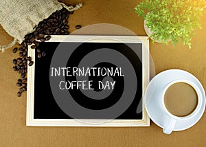 International Coffee Day inscription on the wooden board. International Coffee Day Celebration.