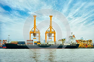 International Container Cargo ship with working crane bridge in shipyard background, logistic import export background and