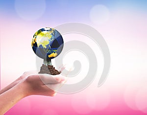 International Day of Cooperatives concept: hands holding Earth  on blurred  nature background