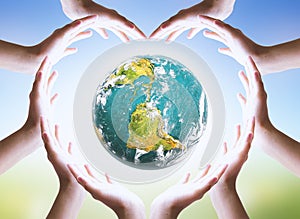 International Day of Friendship concept: Hands holding a heart and Earth symbol