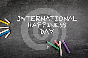 International Day of Happiness 20 March. Gray chalk board background