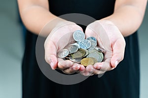 International donation concept - close up of children hands holding euro and international money coins