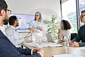 International executive team having board meeting discussing project results.