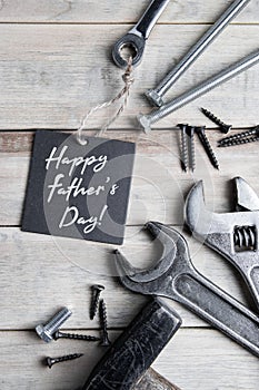 International Father`s Day. Greeting card. Work tools on a gray wooden background