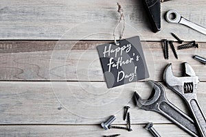 International Father`s Day. Greeting card. Work tools on a gray wooden background