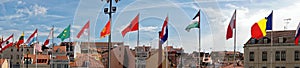 International flags in front of Portuguese city skyline