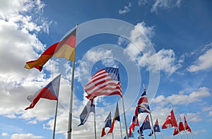 international flags germany usa uk and others on blue sky and wh