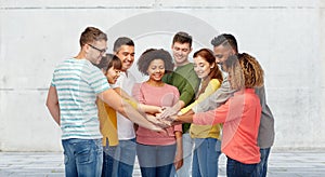 International group of happy people holding hands