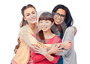 International group of happy women hugging