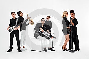 International group of musicians on a white background, guitarist, drummer, soloists, saxophonist. Copy space, relkama