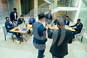 International group of nine african american and indian people having a rest after brain storm in big office