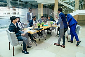 International group of nine african american and indian people having a rest after brain storm in big office