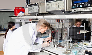 international group of scientists using lab equipment during research