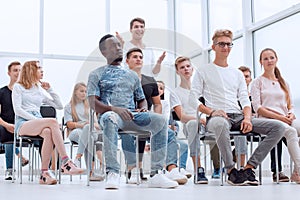 international group of young people sitting in the conference room