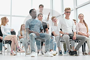 international group of young people sitting in the conference room