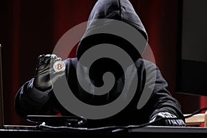 International hacker is trying to steel your crypto currencys. Blockchain security. Thief with laptop is hacking government