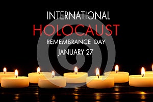 International Holocaust Remembrance Day January 27. Burning candles on black background