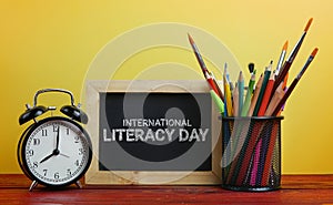 International Literacy Day. Alarm Clock, Blackboard and School S photo