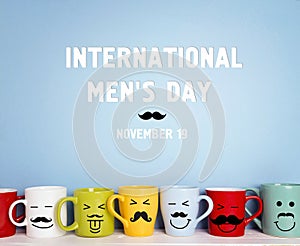 International men`s day background with colorful mugs with a mus