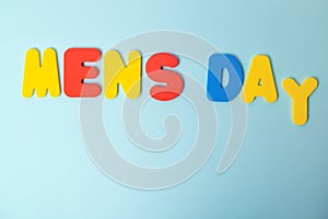 International men`s day inscription in multicolored letters on a blue background. concept men